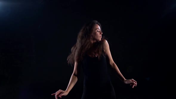 Young Slender Woman Is Dancing in Dark Studio, Rehearsal or Performance of Contemporary Dance alt