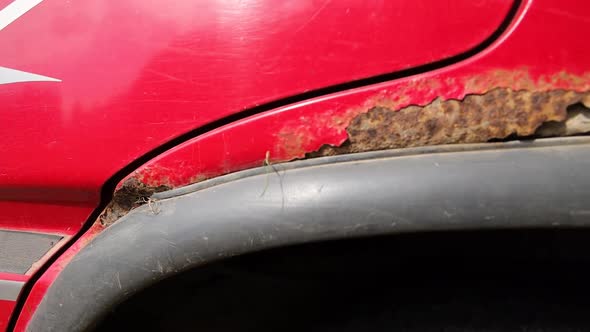 Nasty rust, corrosion on a red cars wheel arches alt