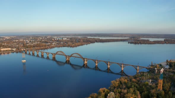 Aerial View on Autumn Landscape with Railway Bridge Above River.