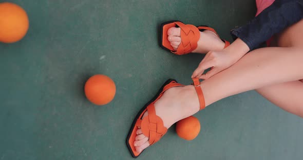Orange Female Sandals on the Legs Vertical Video alt