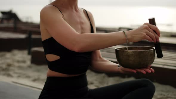 Unrecognizable Woman with Tibetan Singing Bowl for Yoga and Meditation Slowmo alt