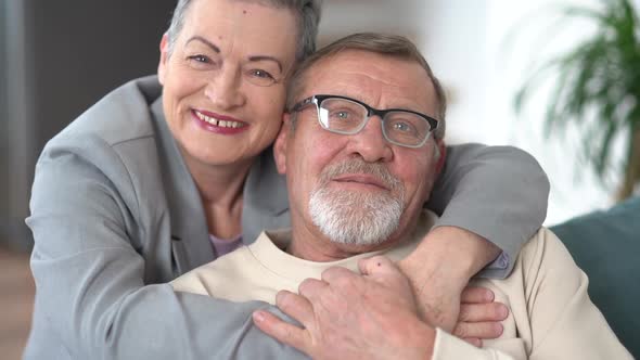 Indore Portrait of a Grayhaired Elderly Married Couple a Man and a Woman Hugging and Looking at the alt
