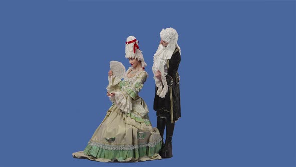 Portrait of Courtier Lady and Gentleman in Historical Vintage Costumes and Wig is Waving a Fan alt