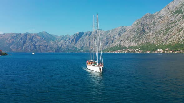 Sailing Yacht in the Bay of Kotor with Beautiful Summer Landscape of the Coastline and Mountains on alt