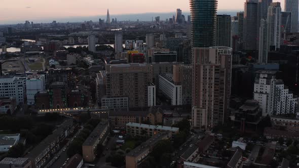 Aerial View of Urban Neighbourhood Tilt Up Reveal Tall Office and Apartment Buildings and City alt