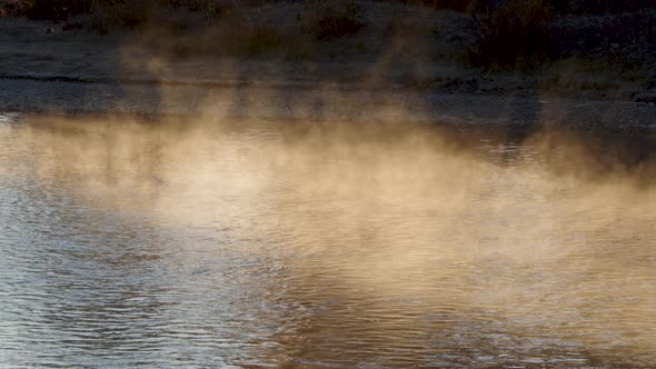 Steam rising over the surface of the Snake River in the sunlight alt