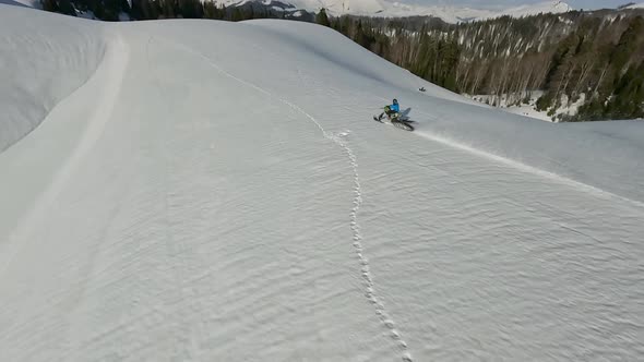 Aerial View Man Riding on Snow Bike at Winter Mountain Summit Enjoy Outdoor Extreme Sport Activity alt