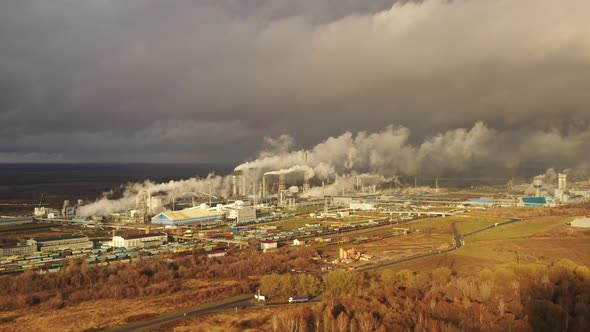 White Smoke Comes Out of a Large Number of Tall Chimneys of Chemical Plants Against the Backdrop of alt