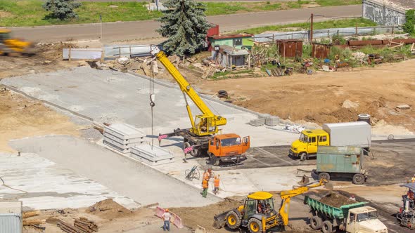 Aerial View of Large Road Construction Site with Several Industrial Machines Timelapse alt