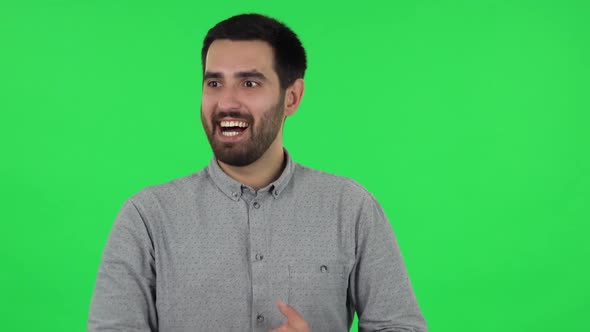 Portrait of Brunette Guy Is Waiting in Anticipation with Pleasure. Green Screen alt