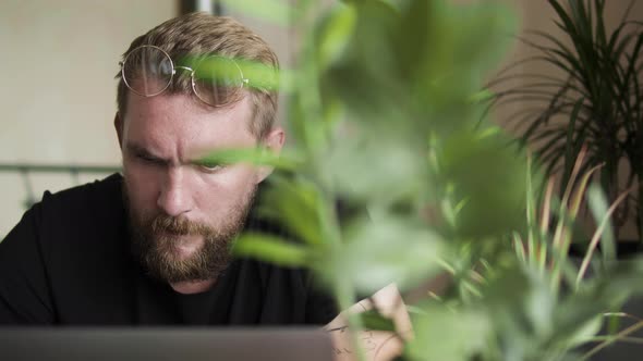 Bearded Man at Computer at Home