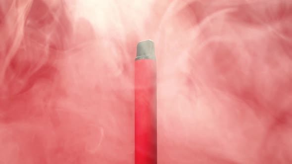 Rotation of one disposable red e-cigarettes, and vapes in with smoke