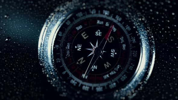 Compass in the Rain Drops on Glass alt