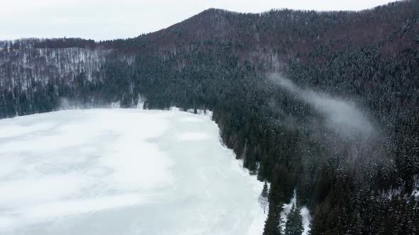 Frozen volcanic Saint Ann or Sfanta Ana lake crater, Romania. Aerial rising alt