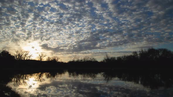 Brilliant Sunrise Clouds Over Lake Timelapse Wide Shot