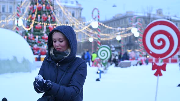 Young Woman Sculpts Snow alt