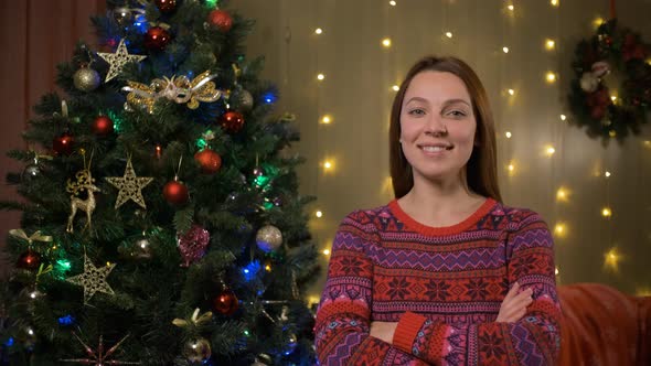 Portrait Of Young Woman Happy and Excited Standing During Christmas Tree