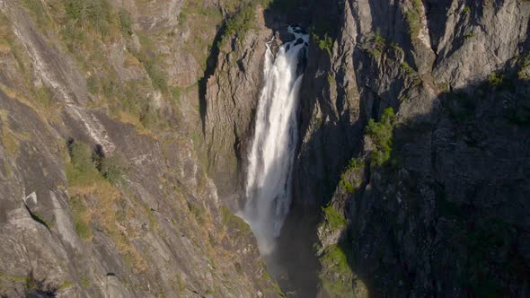 Beautiful cinematic drone shot of a waterfall in a mountain valley, Norway alt
