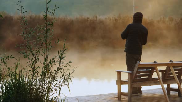 Man Enjoy Hobby at the Riverbank