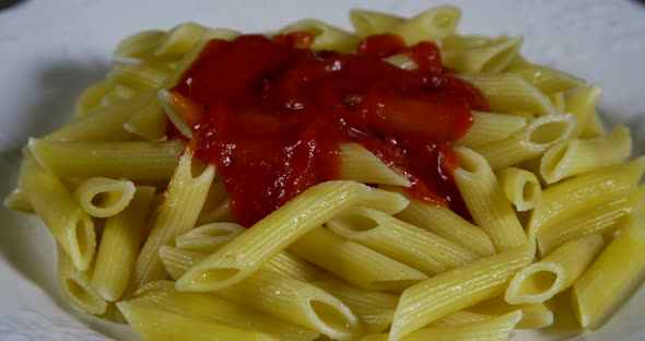 Putting Tomato Sauce On Penne Pasta 43b