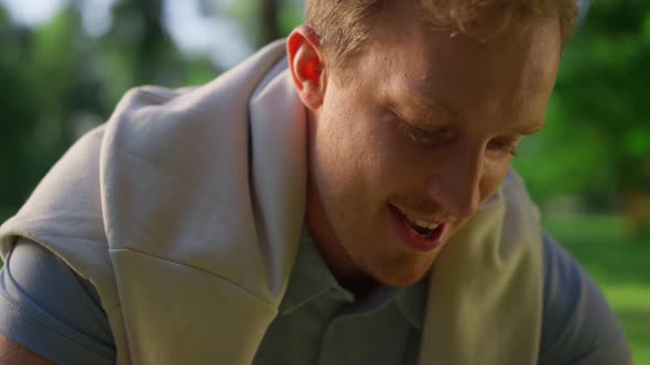 Joyful Guy Talking Paddle in Park Closeup alt