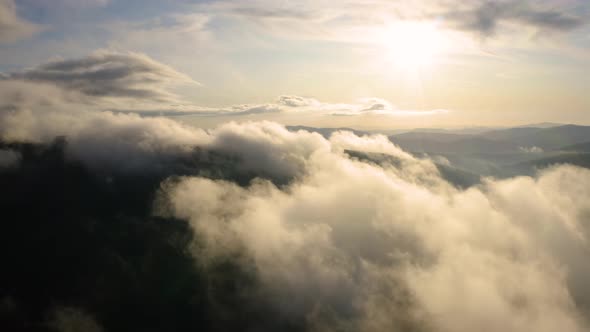 Fly up over Organic Clouds, Aerial Landscape above Mountain in Spring Season alt