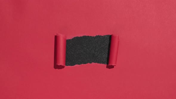 Red Paper Opening Ripping To Reveal Black Copy Space 4444
