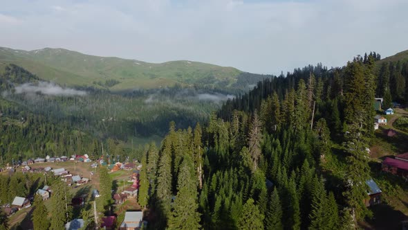 Misty Aerial View Of High Mountain Village alt