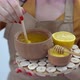 Cropped View of Woman Mixing Honey with Lemon on White Background - VideoHive Item for Sale