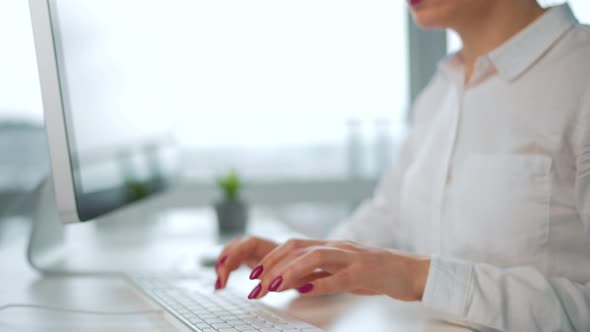 Woman Typing on a Computer Keyboard alt