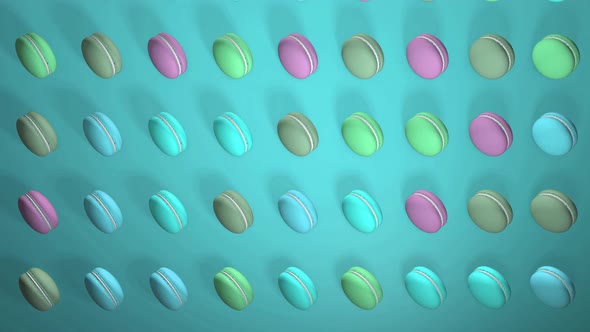 Multicolored macaron pastries on light turquoise paper background
