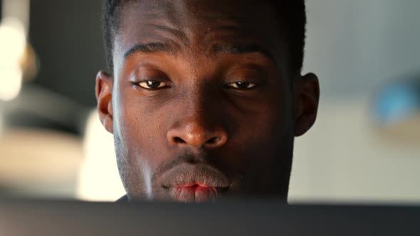 Portrait of young student talking using computer at home office alt