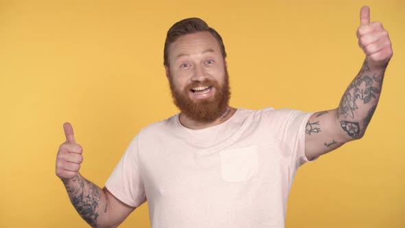 Bearded man showing thumbs up gesture.