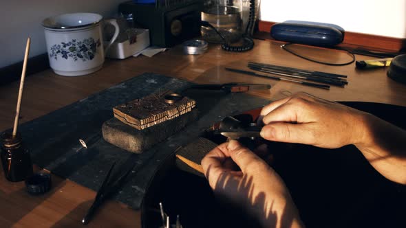 Goldsmith preparing ring alt