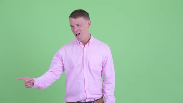 Portrait of Happy Businessman Looking Around and Feeling Excited alt