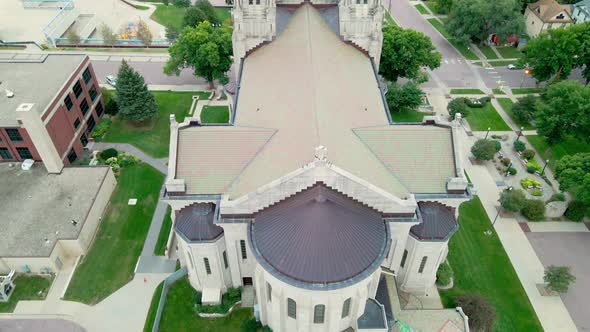 Birds eye view over religious building rooftop and surrounding buildings and neighborhood.