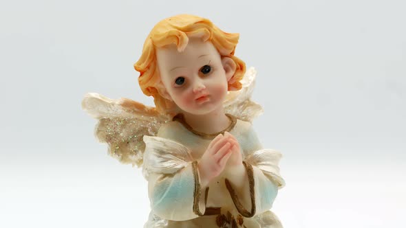 Beautiful Little Angel Statuette on a White Background 