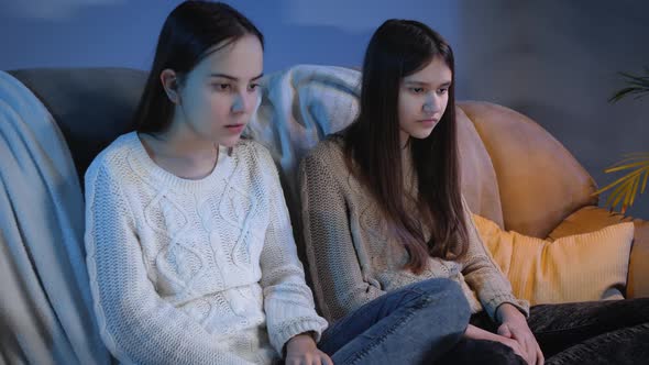 Two Girls Watching Scary or Bad TV Show and Feeling Disgusting alt