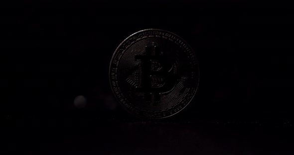 New Virtual Currency with One Silver Bitcoin Close Up on Black Background alt