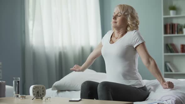 Awakening of Beautiful Happy Mature Woman. Blonde Sitting on Her Bed, Morning alt