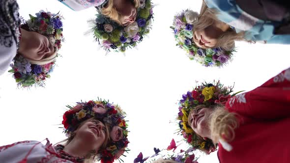 Bottom Angle View Group of Ukrainian Beautiful Women in Head Wreathes and National Clothes Walking alt