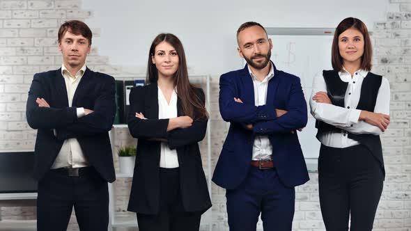 Group of Friendly Stylish Young Business People in Suit Posing with Crossed Hand at Office alt