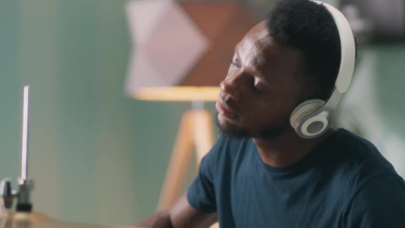 Glad Black Male Playing Drums at Home alt