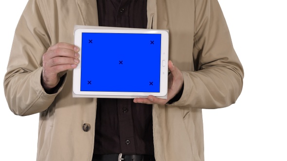 Male hands holding tablet with blue screen mockup on white alt