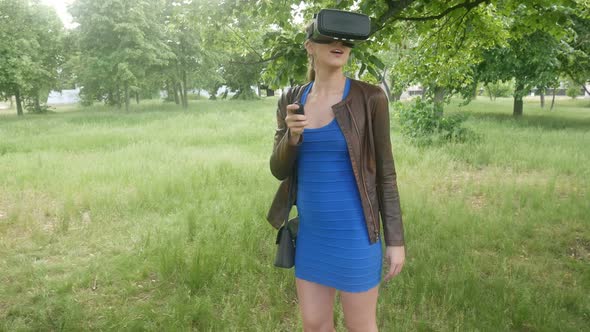 Sexy Beautiful Girl Uses Modern Helmet Virtual Reality On Nature alt