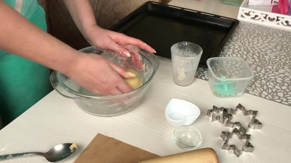 A Woman Mixes A Lump Of Dough For Making Biscuit Cookies. alt