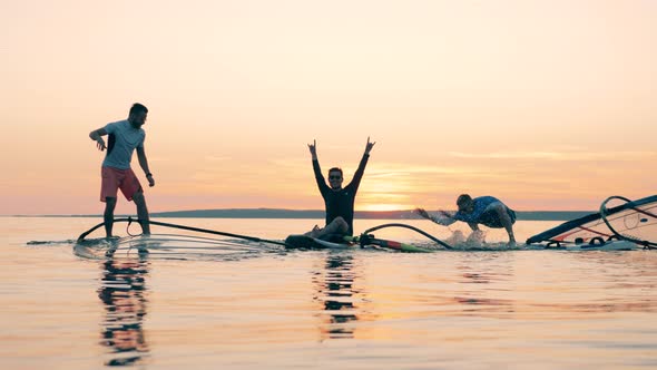Men Are Fooling Around on Sailboards in the Ocean alt