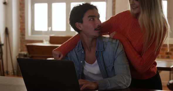 Happy couple spending time together in their apartment alt