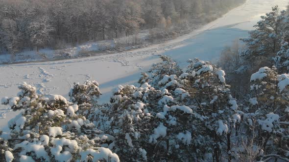 Aerial an Icy River in a Wooded Area alt