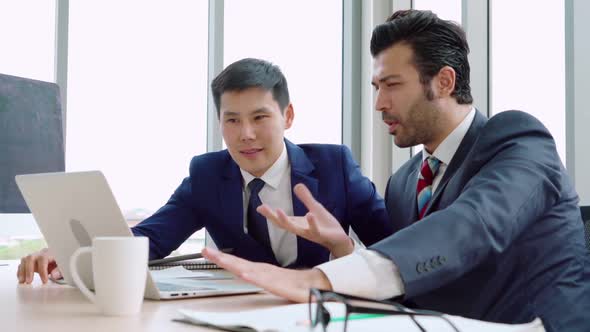 Two Business People Talk Project Strategy at Office alt